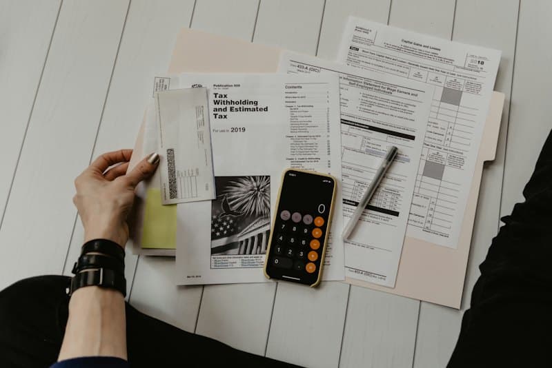 Mortgage documents and a calculator on a lender’s desk
