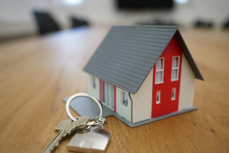 House keys beside a small model home